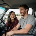 Jake and Lisa laughing together inside a truck cab, a MileDating trucker dating success story