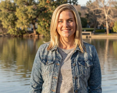 Lauren, a 33-year-old blonde woman in a denim jacket at White Rock Lake Dallas, featured on MileDating trucker dating Dallas
